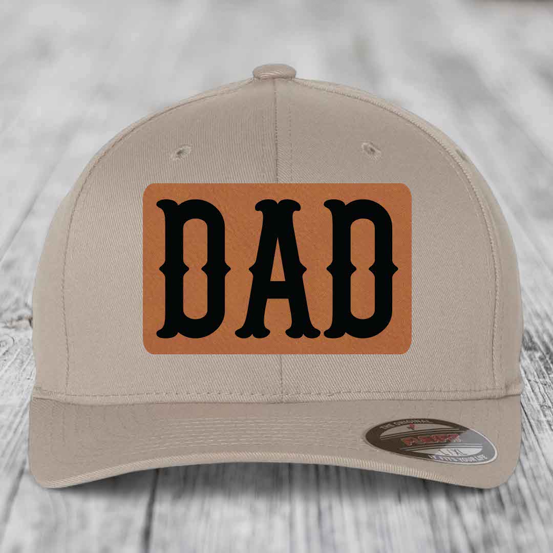 Dark blue baseball cap with a light brown leatherette patch that says &