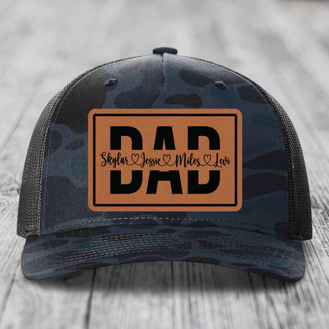 Camouflage trucker hat with brown leather patch reading &