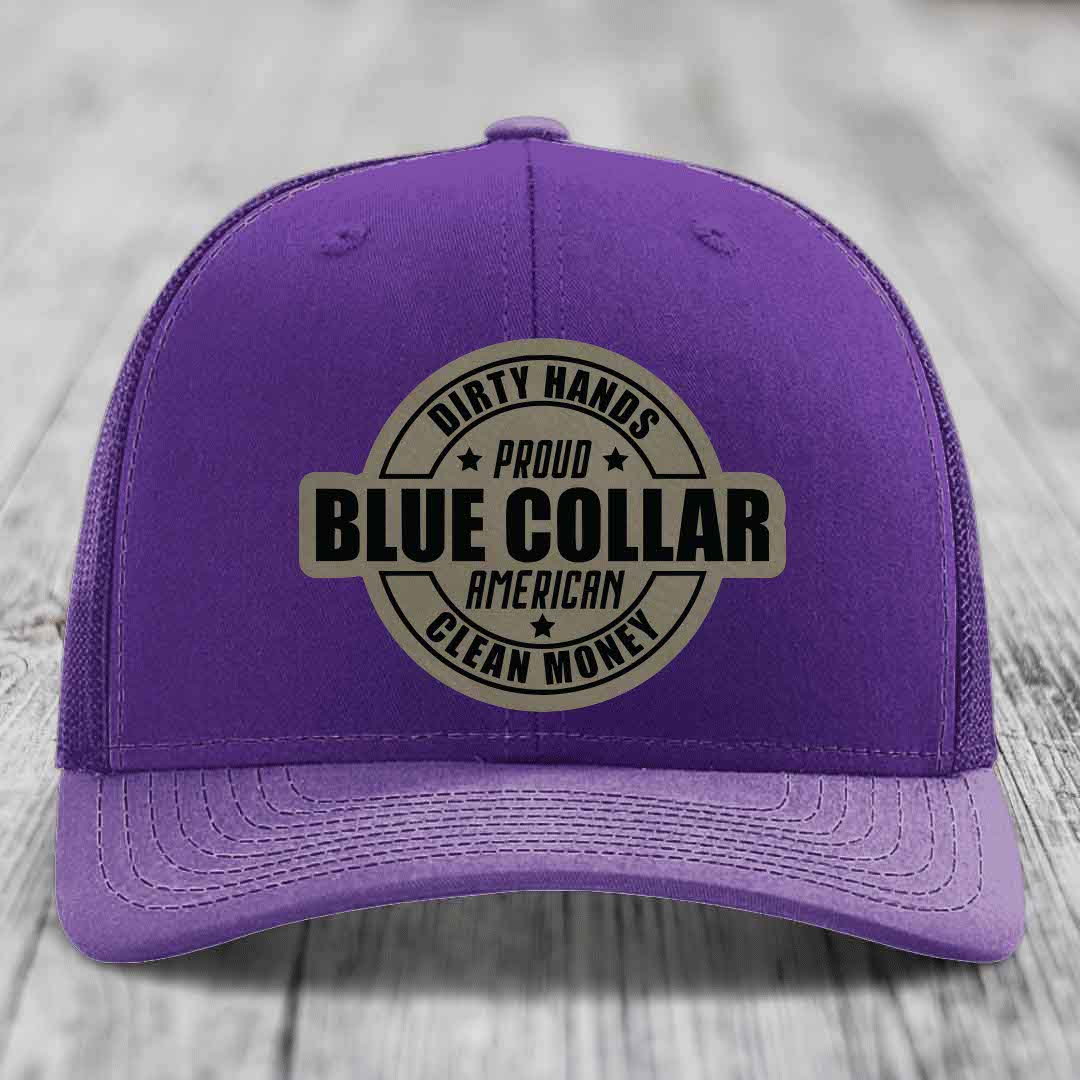 Red trucker hat with black mesh back and beige circular patch reading &