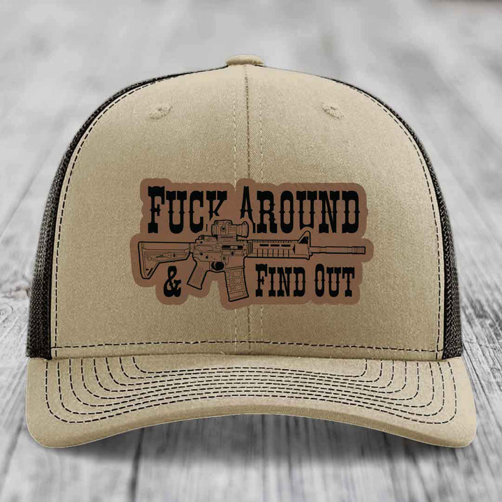 Tan trucker hat with black mesh back, featuring a leatherette patch with &