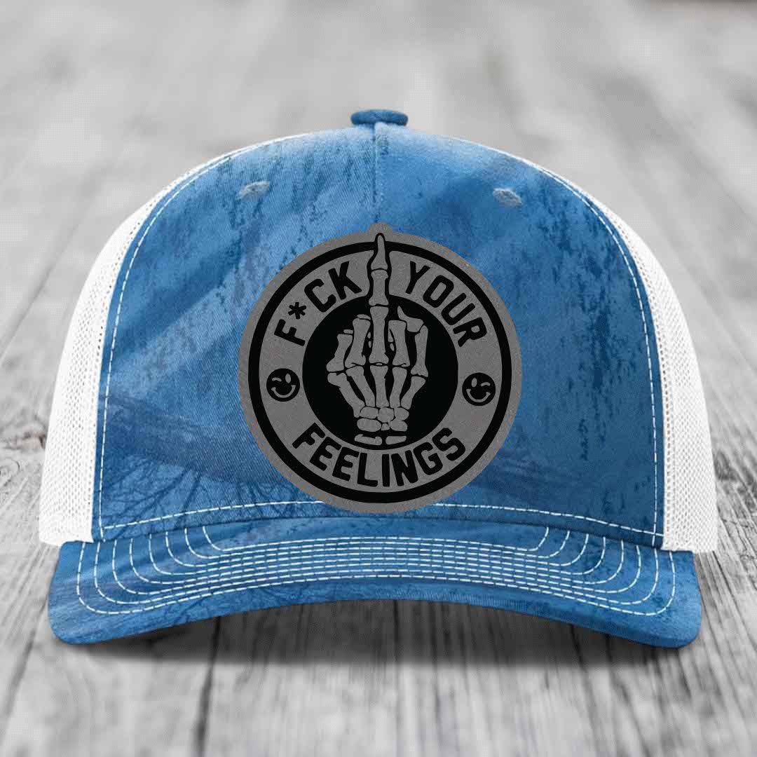 Blue and white trucker hat with a circular patch showing a skeleton hand and the text &