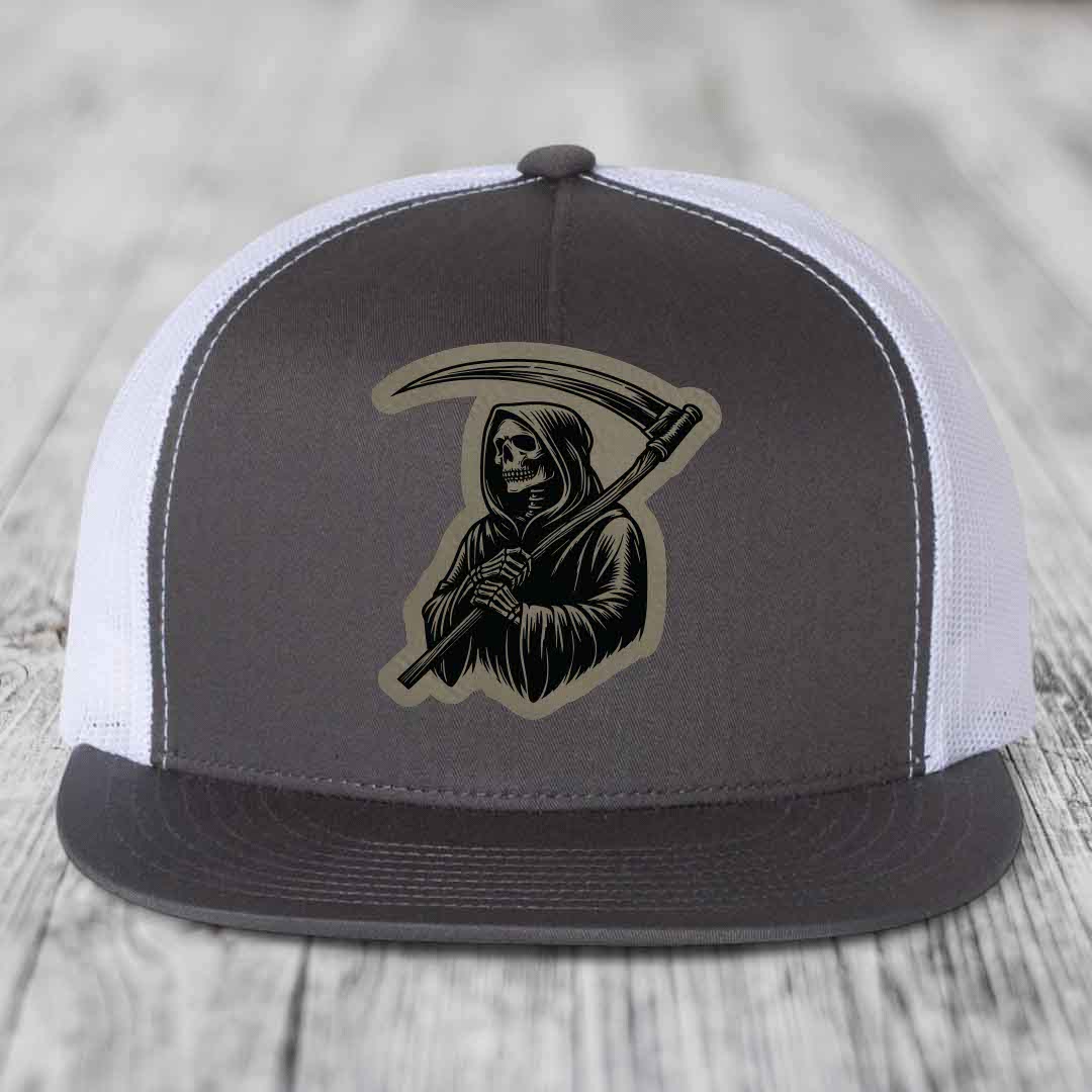 Grey and white trucker hat with Grim Reaper leather patch on front.