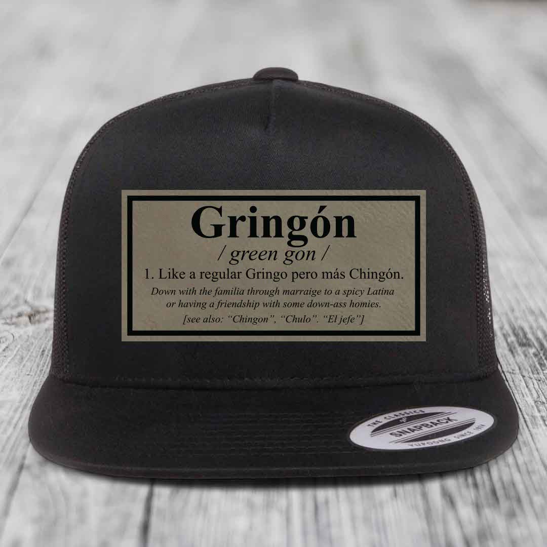 Black snapback trucker hat with a beige leatherette patch defining &