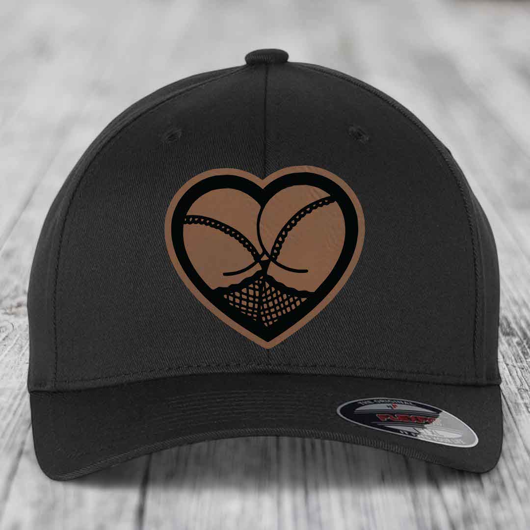Black baseball cap with heart-shaped leatherette patch featuring two crossed stockings.