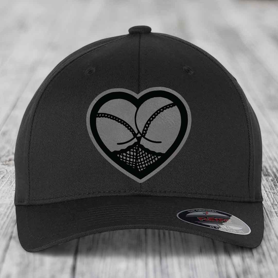 Black baseball cap with heart-shaped patch featuring a stylized ass design.