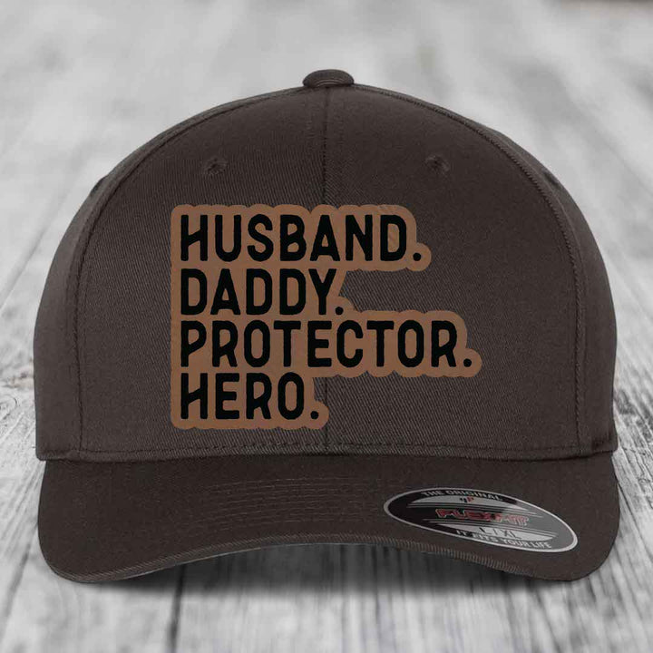 Husband Daddy Protector Hero - Leather Patch Hat - Dark Brown to Black Patch - Flexfit 6277 Fitted Hat