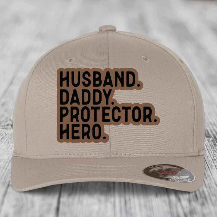 Husband Daddy Protector Hero - Leather Patch Hat - Dark Brown to Black Patch - Flexfit 6277 Fitted Hat