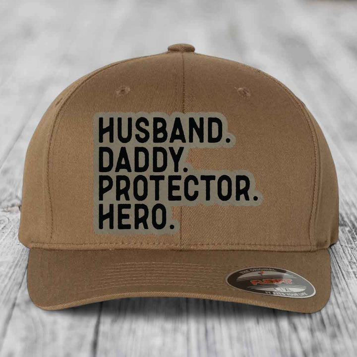 Husband Daddy Protector Hero - Leather Patch Hat - Light Brown to Black Patch - Flexfit 6277 Fitted Hat