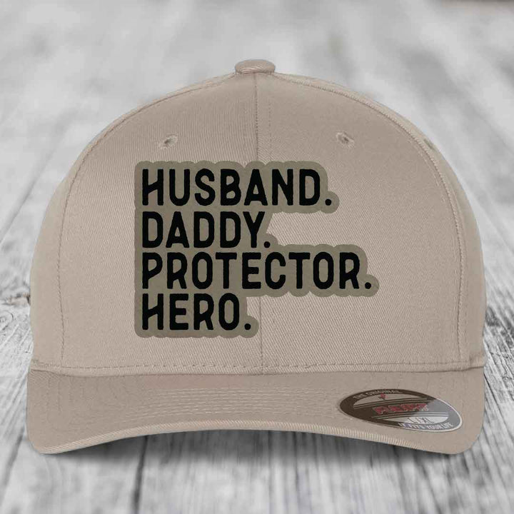Husband Daddy Protector Hero - Leather Patch Hat - Light Brown to Black Patch - Flexfit 6277 Fitted Hat