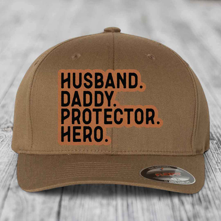 Husband Daddy Protector Hero - Leather Patch Hat - Rawhide to Black Patch - Flexfit 6277 Fitted Hat