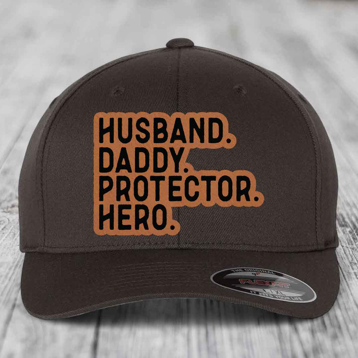 Husband Daddy Protector Hero - Leather Patch Hat - Rawhide to Black Patch - Flexfit 6277 Fitted Hat