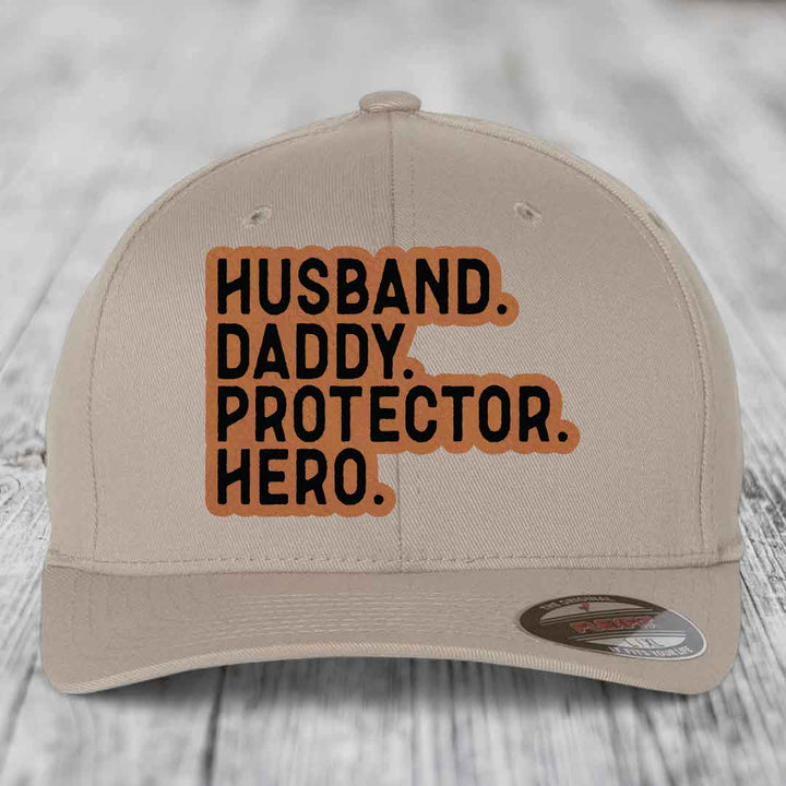 Husband Daddy Protector Hero - Leather Patch Hat - Rawhide to Black Patch - Flexfit 6277 Fitted Hat