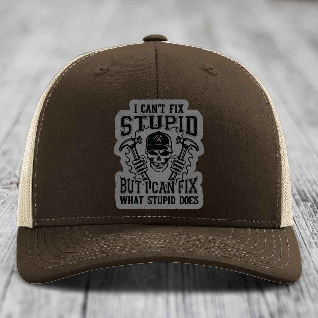Brown trucker hat with gray patch featuring skull holding hammers and text &