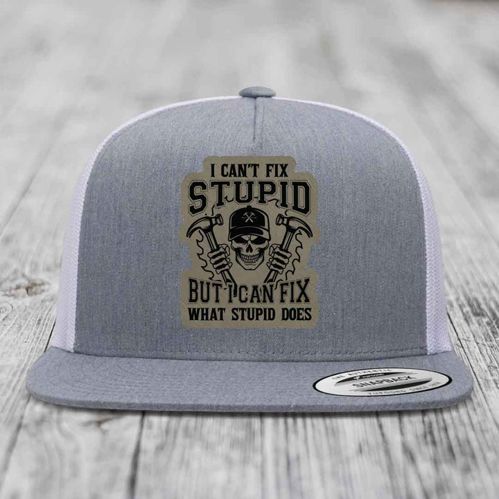 Grey trucker hat with black and tan patch featuring skull holding hammers and text &