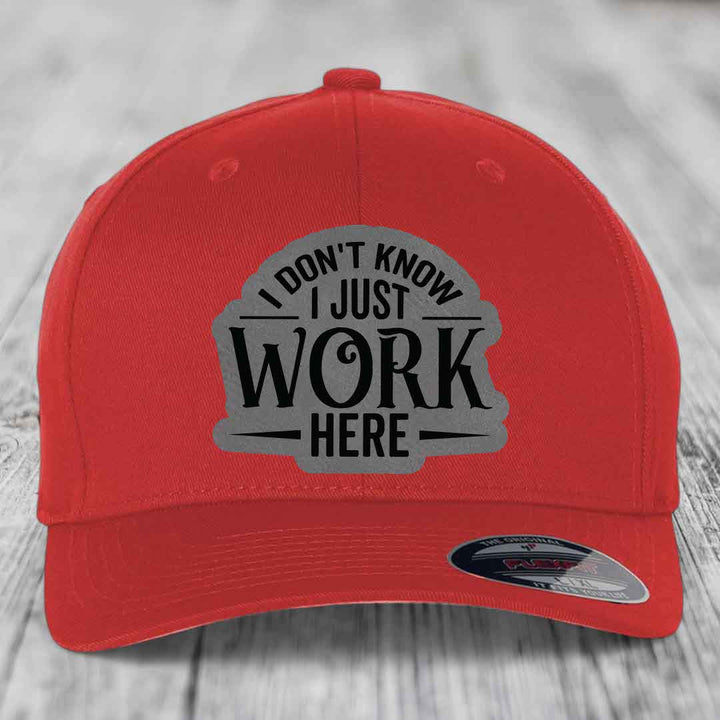 Red baseball cap with gray patch reading &