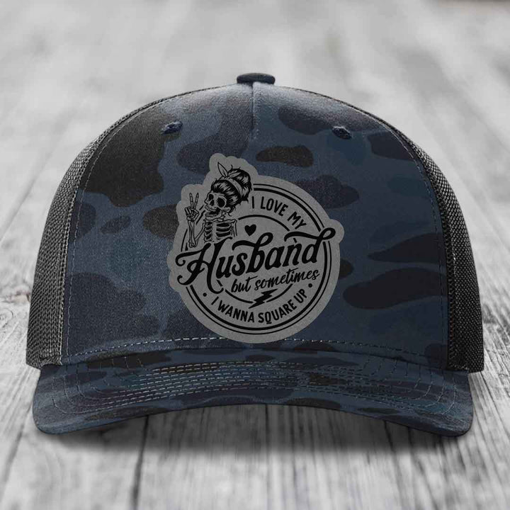 Camouflage trucker hat with skull patch reading &