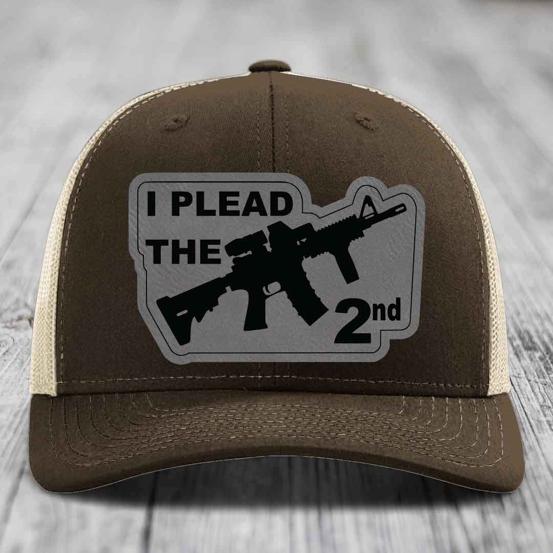 Brown trucker hat with beige mesh back and gray patch reading &