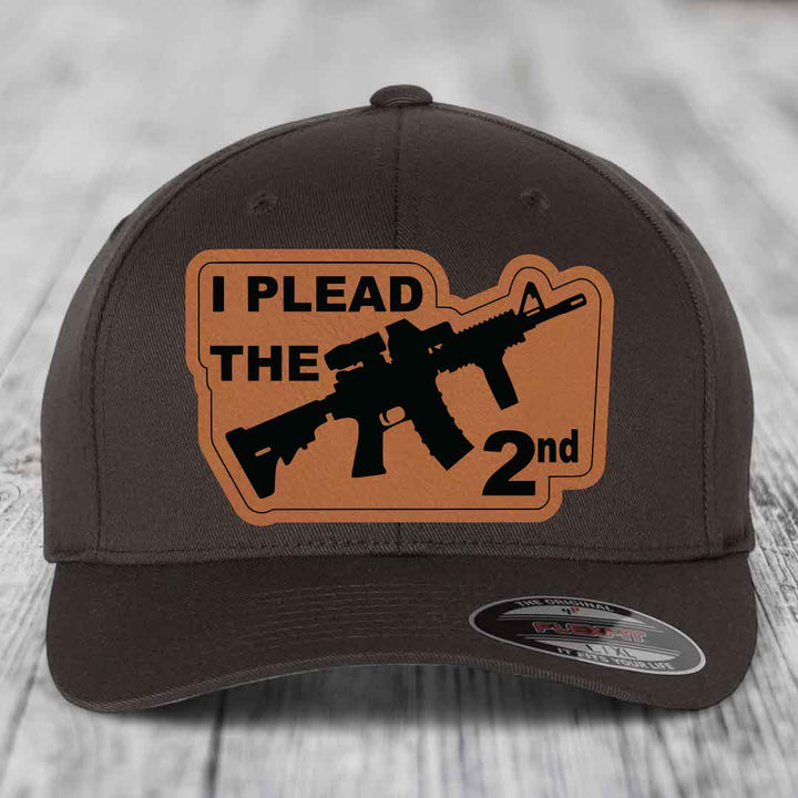 Dark brown baseball cap with tan leather patch reading &