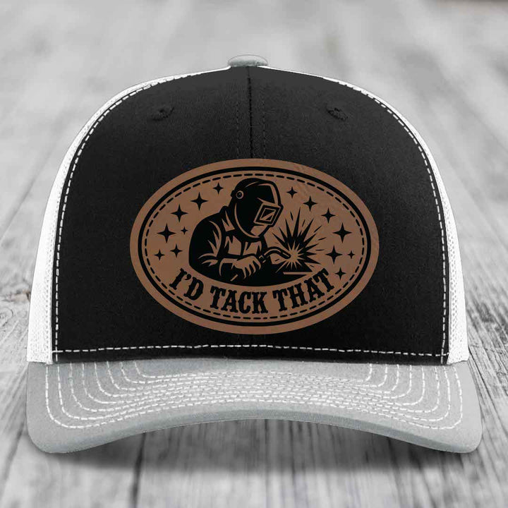 Black and white trucker hat with brown leather patch showing welder and text &