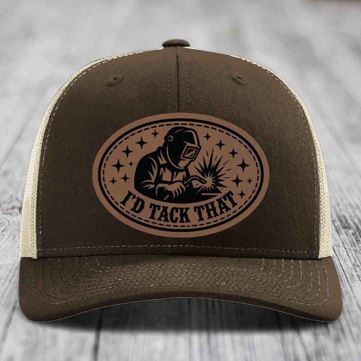 Brown trucker hat with beige mesh back and a brown leatherette patch showing a welder and text &