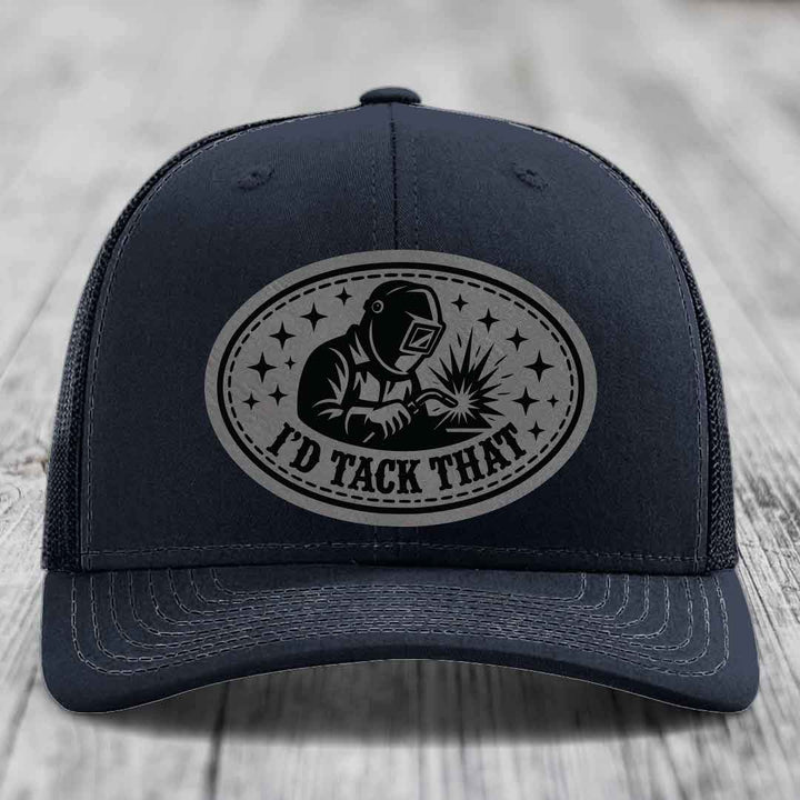 Dark blue trucker hat with gray oval patch showing welder and text &