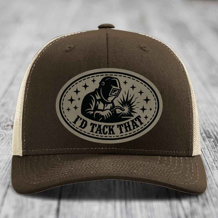 Brown trucker hat with beige mesh back and black embroidered patch showing welder with &