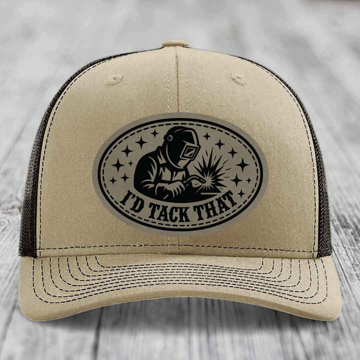Beige trucker hat with black embroidered patch showing welder and text &