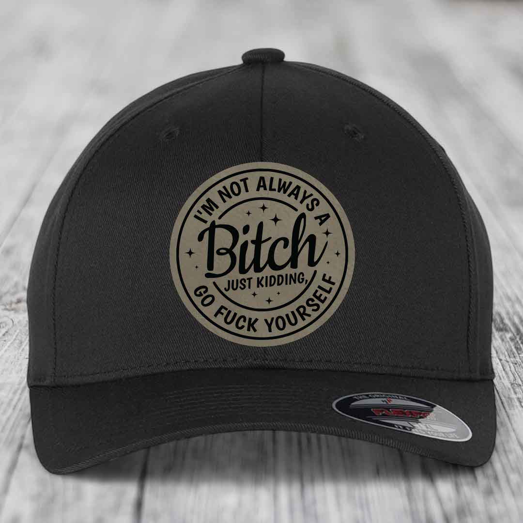 Black baseball cap with circular beige patch reading &