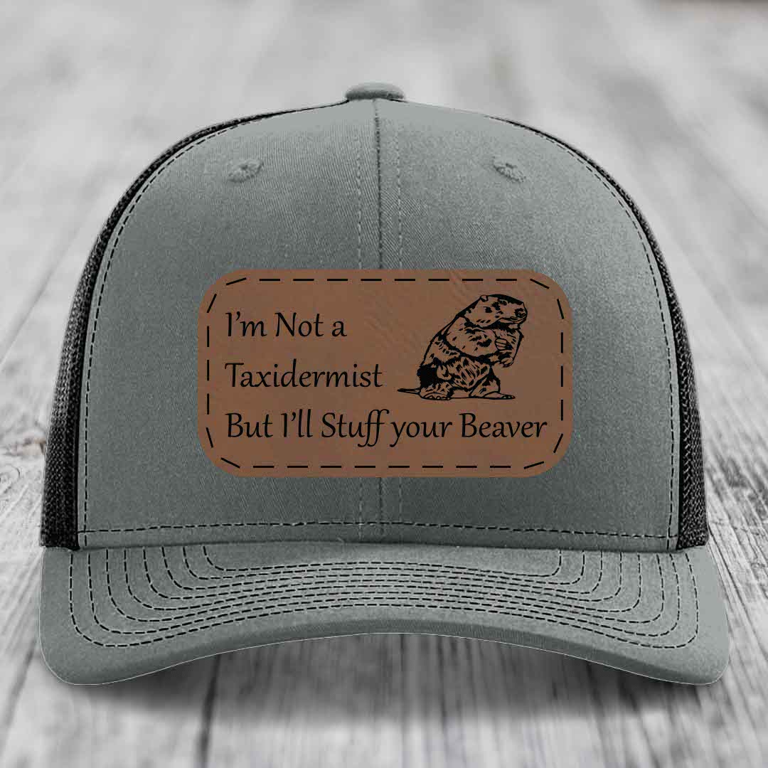 Grey trucker hat with brown leather patch reading &
