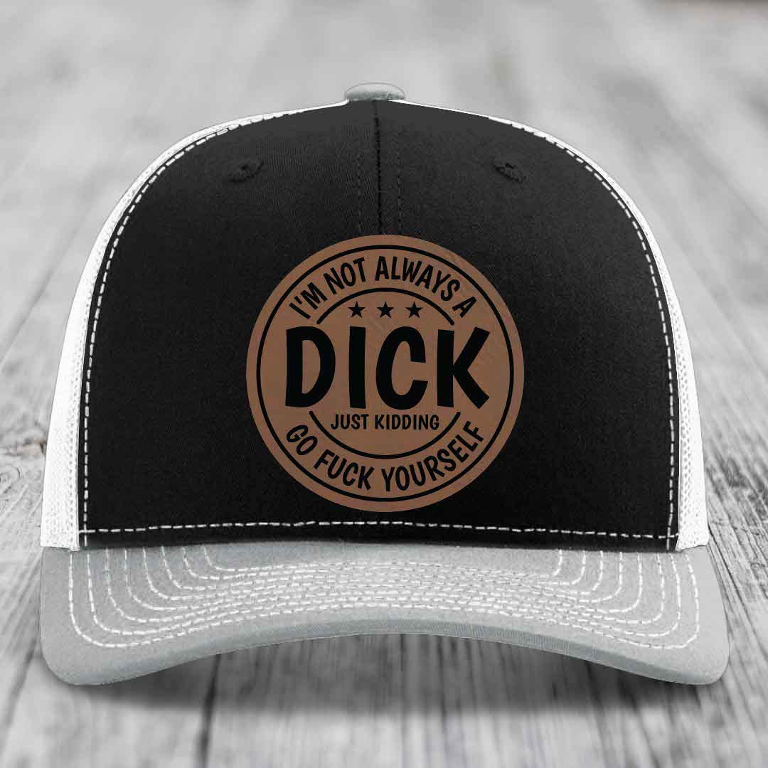 Black and white trucker hat with brown circular leather patch reading &