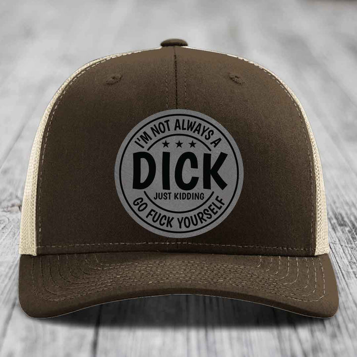 Brown trucker hat with black and grey circular patch reading &