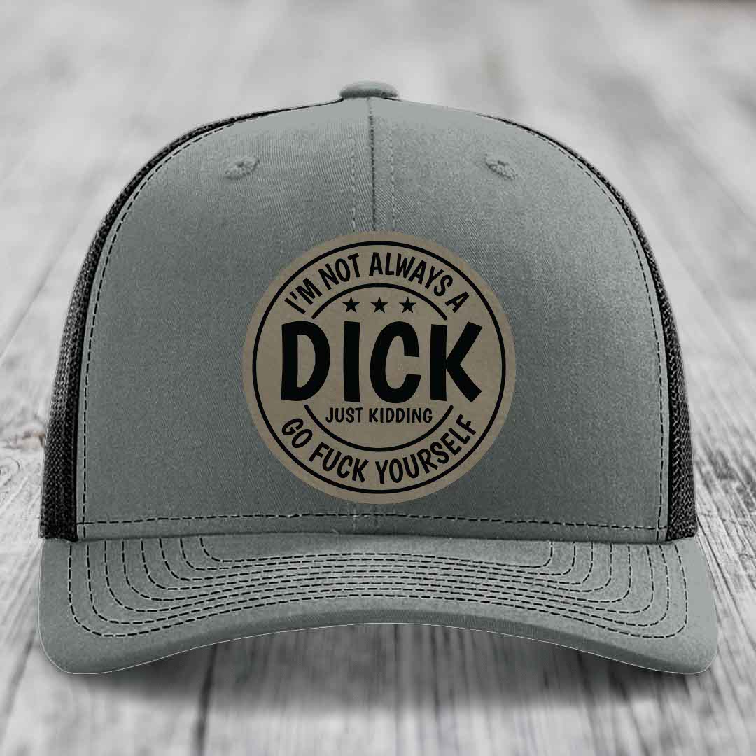 Grey trucker hat with black mesh back and a circular leather patch that reads &