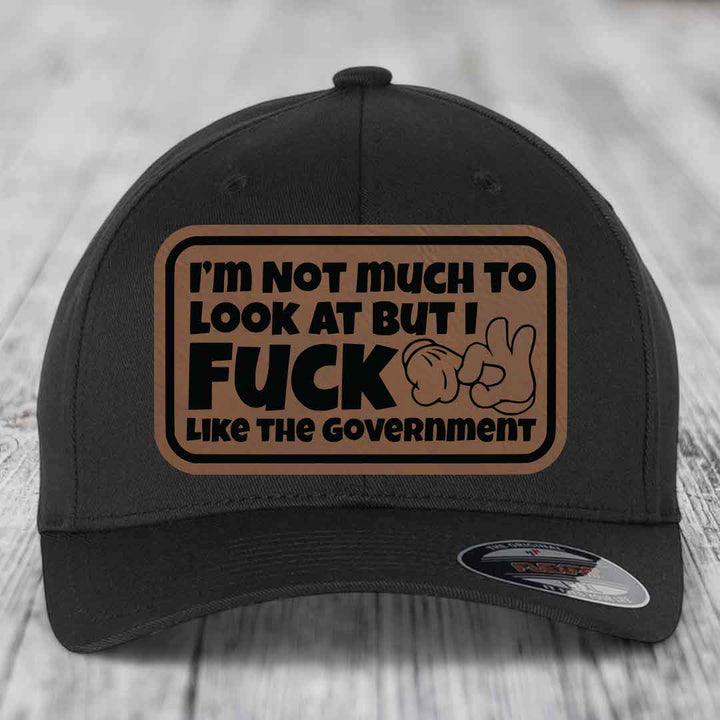 Im Not Much To Look At, But I F*ck Like The Government - Leather Patch Hat - Dark Brown to Black Patch - Flexfit 6277 Fitted Hat