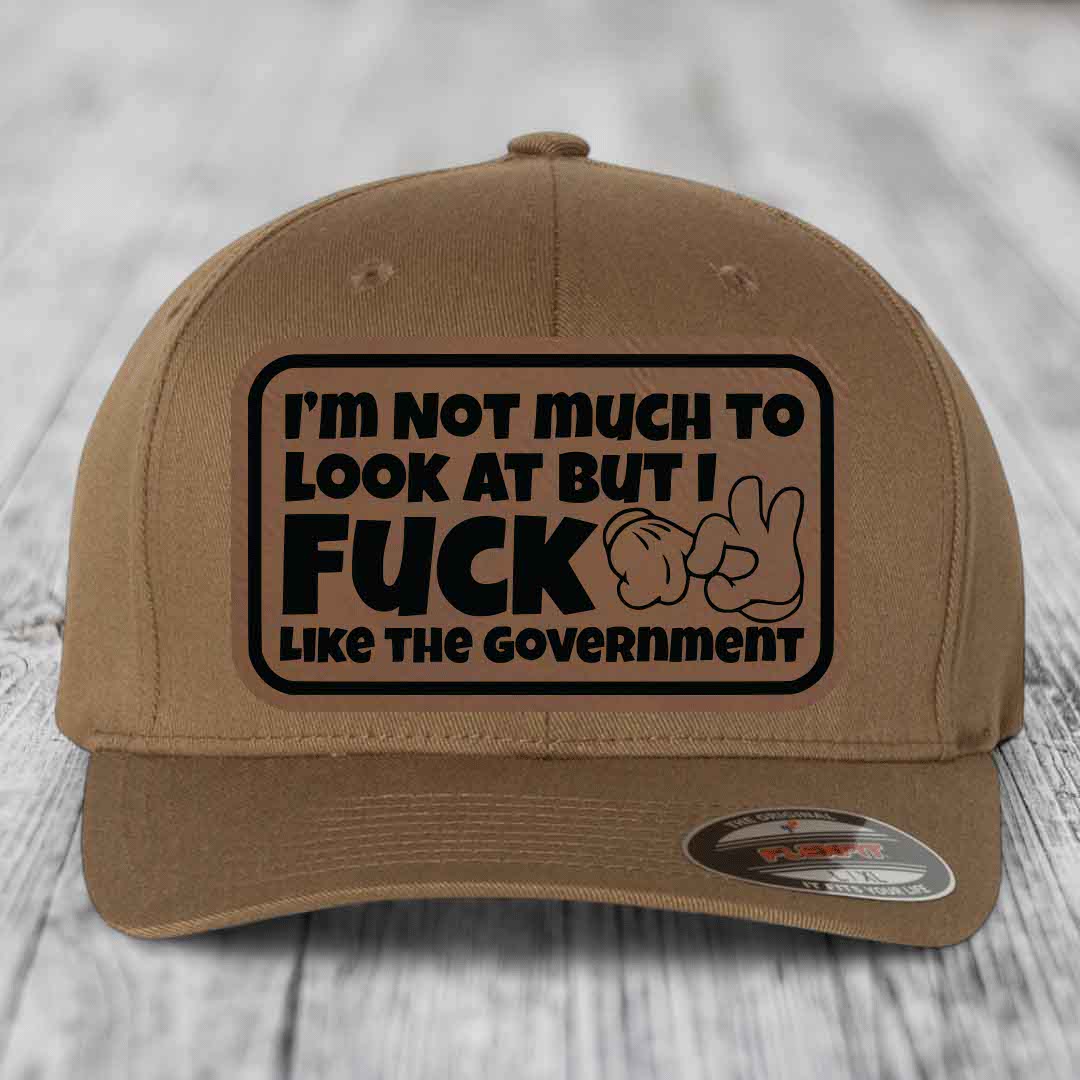 Im Not Much To Look At, But I F*ck Like The Government - Leather Patch Hat - Dark Brown to Black Patch - Flexfit 6277 Fitted Hat