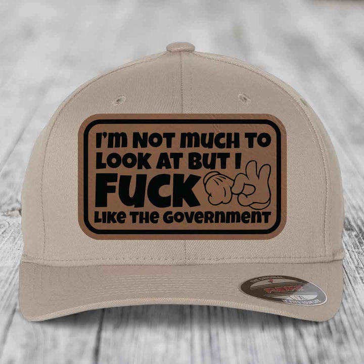 Im Not Much To Look At, But I F*ck Like The Government - Leather Patch Hat - Dark Brown to Black Patch - Flexfit 6277 Fitted Hat