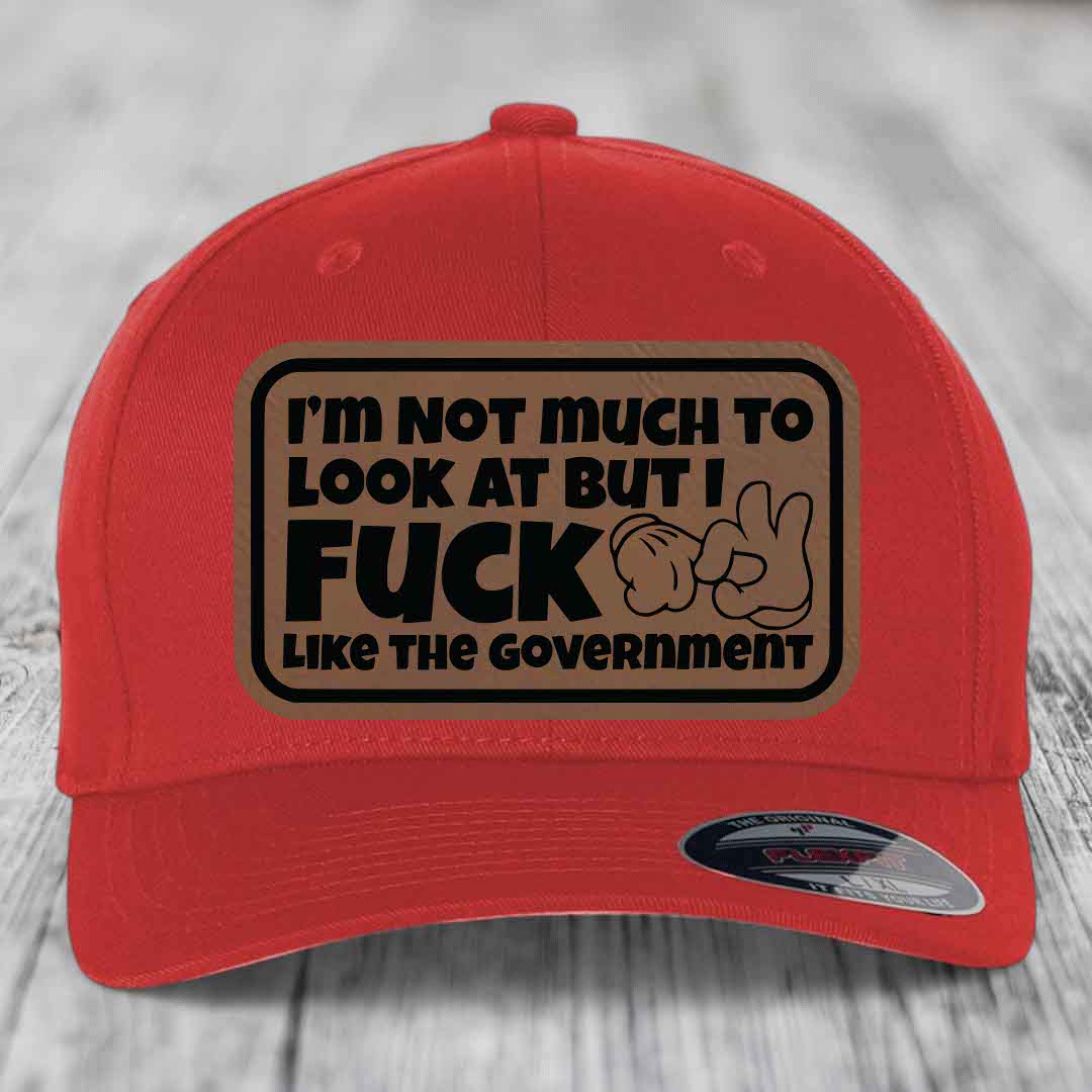 Im Not Much To Look At, But I F*ck Like The Government - Leather Patch Hat - Dark Brown to Black Patch - Flexfit 6277 Fitted Hat