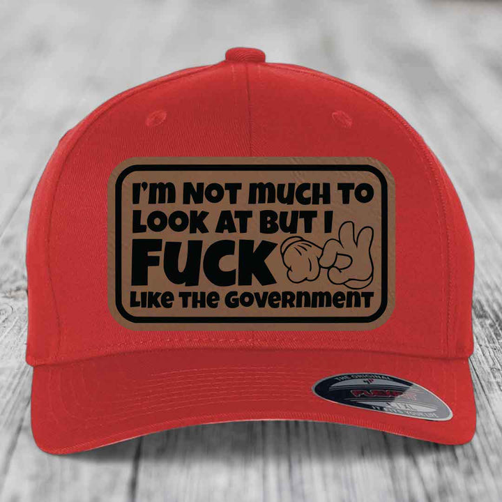 Im Not Much To Look At, But I F*ck Like The Government - Leather Patch Hat - Dark Brown to Black Patch - Flexfit 6277 Fitted Hat