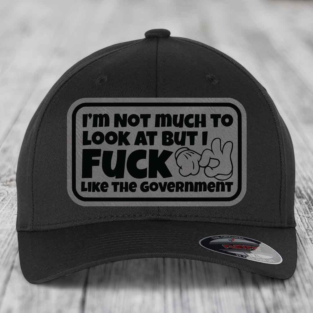 Black baseball cap with rectangular patch reading &