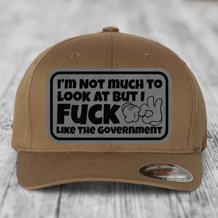 Im Not Much To Look At, But I F*ck Like The Government - Leather Patch Hat - Grey to Black Patch - Flexfit 6277 Fitted Hat