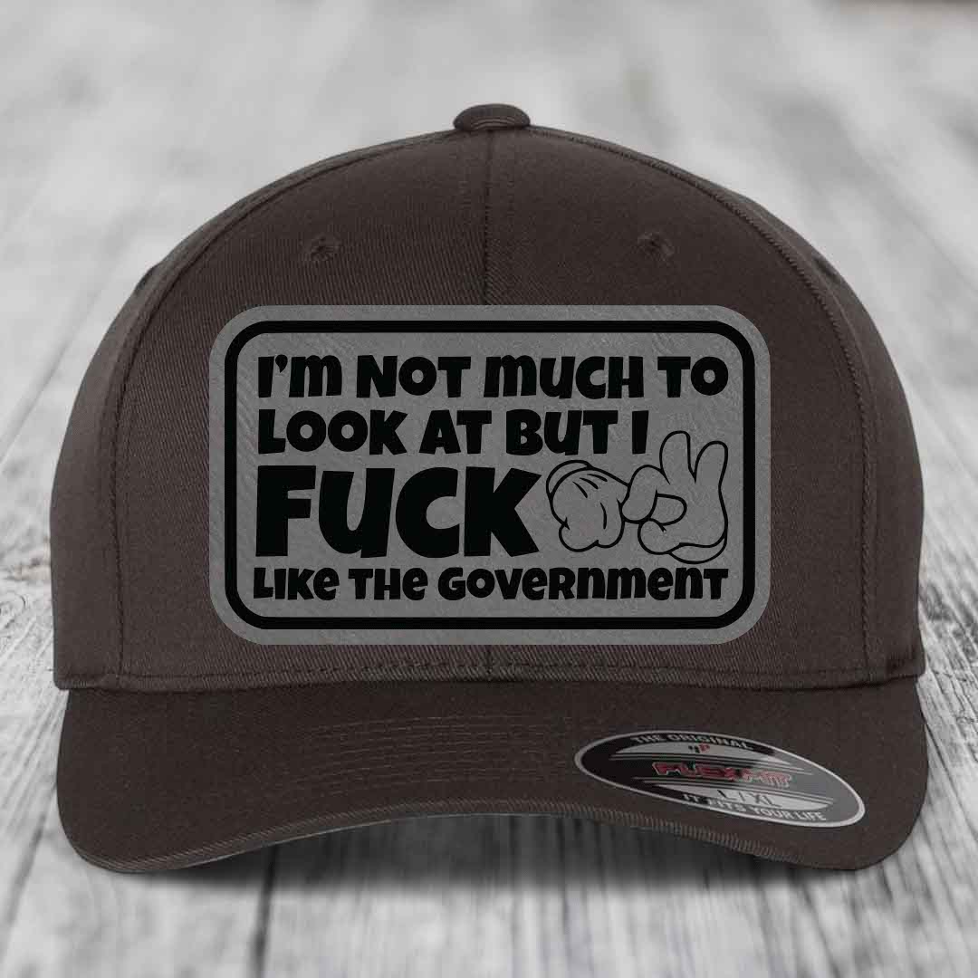 Im Not Much To Look At, But I F*ck Like The Government - Leather Patch Hat - Grey to Black Patch - Flexfit 6277 Fitted Hat