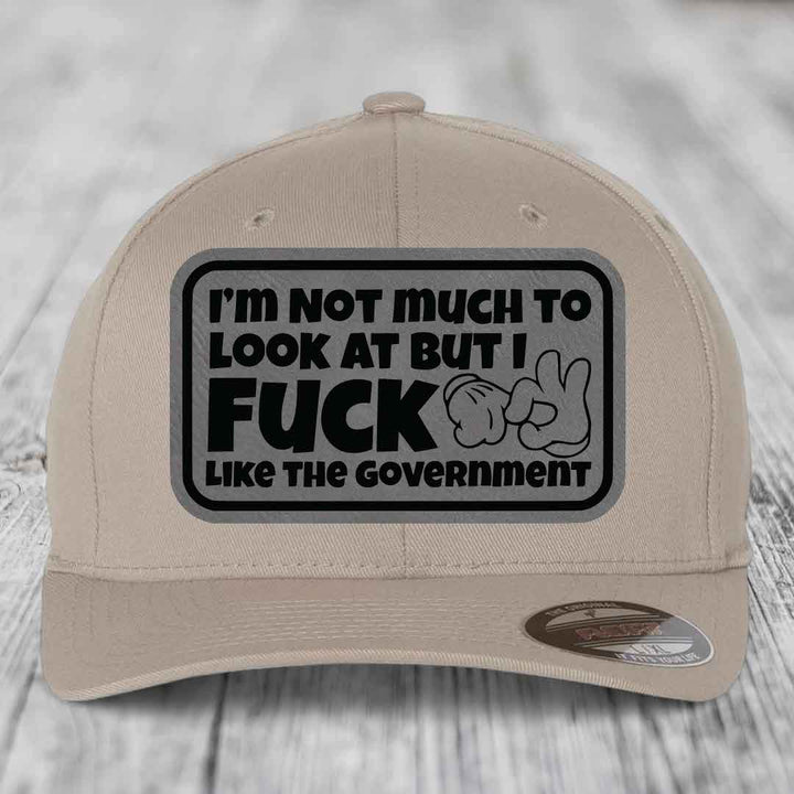 Im Not Much To Look At, But I F*ck Like The Government - Leather Patch Hat - Grey to Black Patch - Flexfit 6277 Fitted Hat