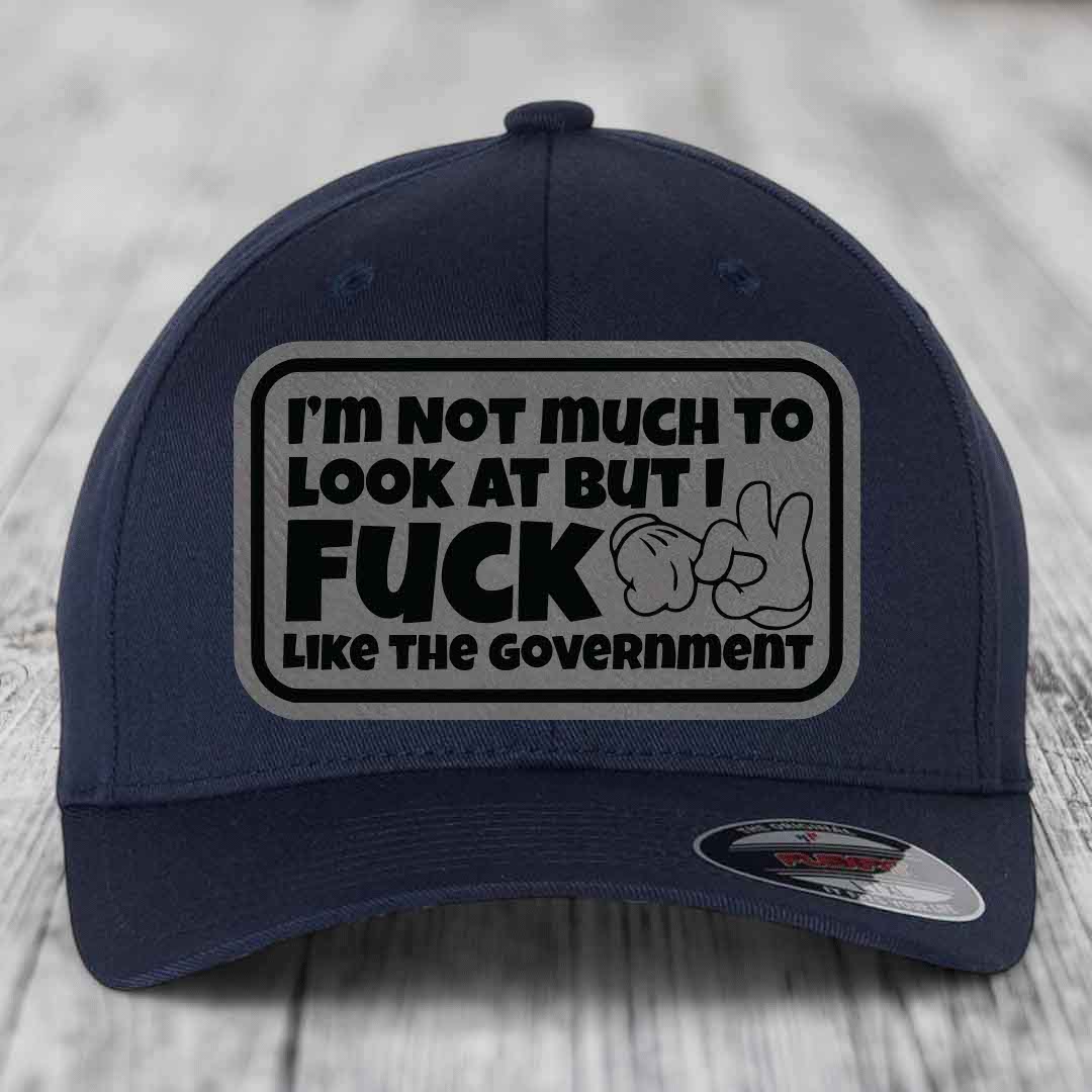 Im Not Much To Look At, But I F*ck Like The Government - Leather Patch Hat - Grey to Black Patch - Flexfit 6277 Fitted Hat
