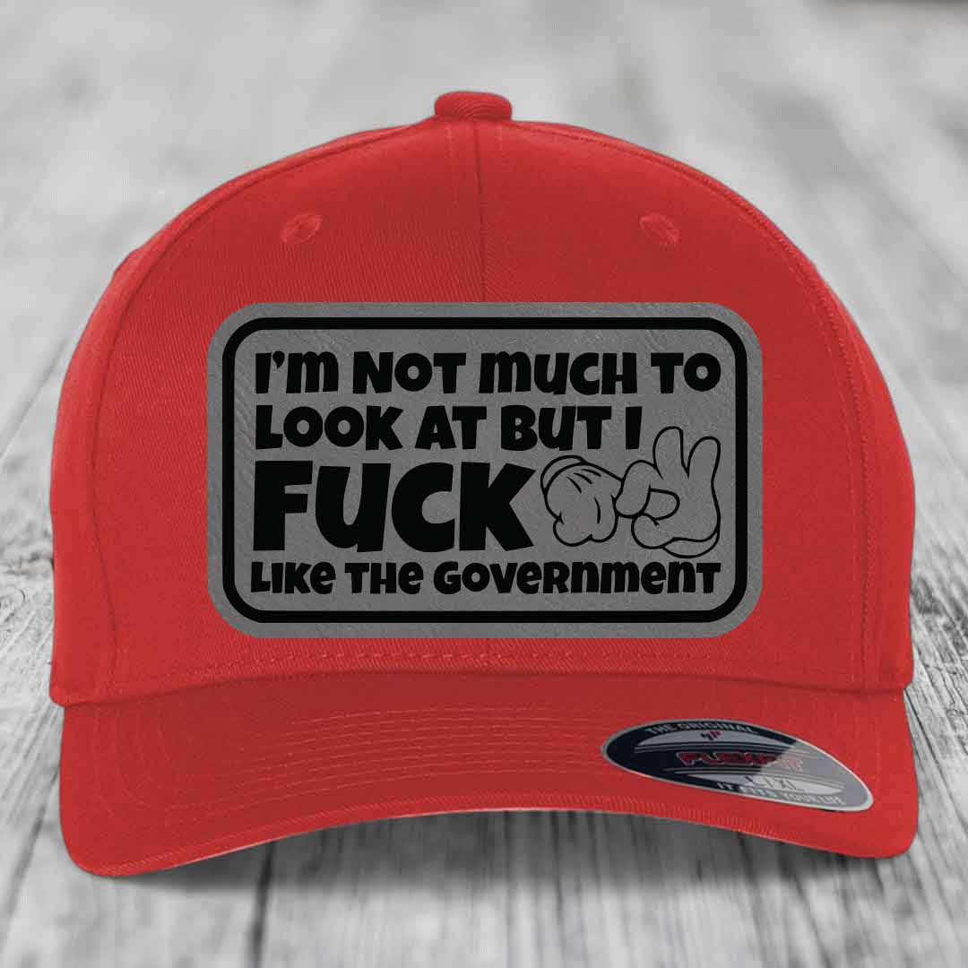 Im Not Much To Look At, But I F*ck Like The Government - Leather Patch Hat - Grey to Black Patch - Flexfit 6277 Fitted Hat