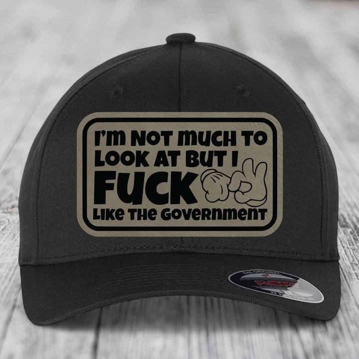 Im Not Much To Look At, But I F*ck Like The Government - Leather Patch Hat - Light Brown to Black Patch - Flexfit 6277 Fitted Hat
