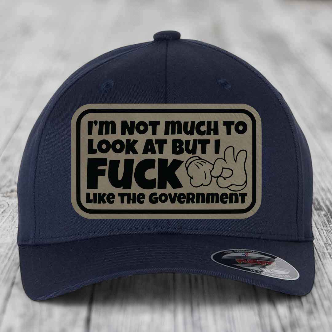 Im Not Much To Look At, But I F*ck Like The Government - Leather Patch Hat - Light Brown to Black Patch - Flexfit 6277 Fitted Hat