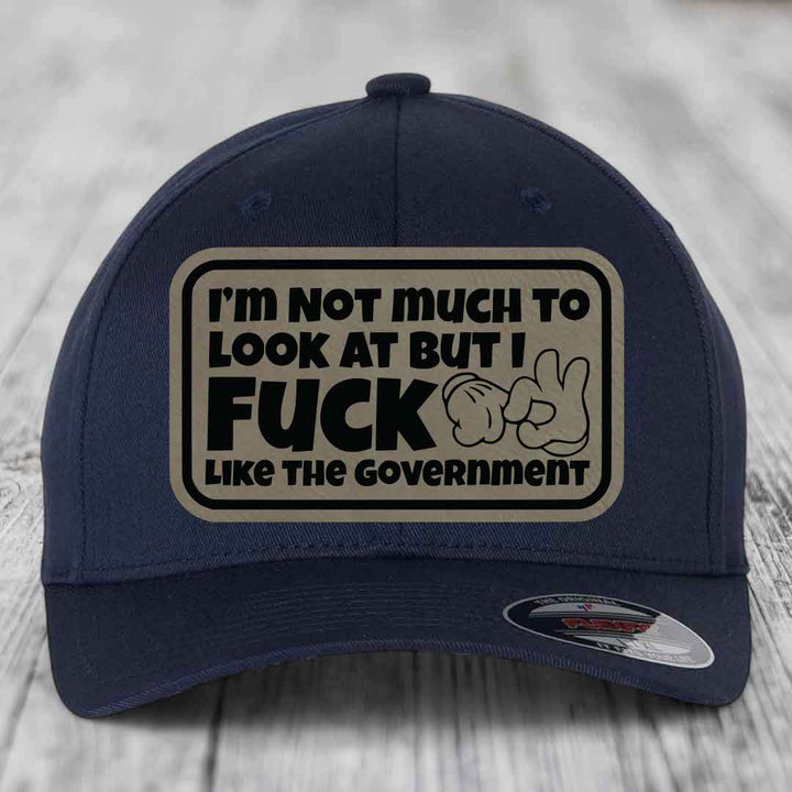Im Not Much To Look At, But I F*ck Like The Government - Leather Patch Hat - Light Brown to Black Patch - Flexfit 6277 Fitted Hat