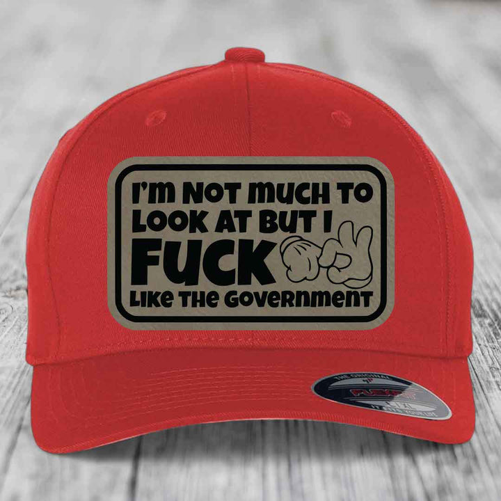 Im Not Much To Look At, But I F*ck Like The Government - Leather Patch Hat - Light Brown to Black Patch - Flexfit 6277 Fitted Hat