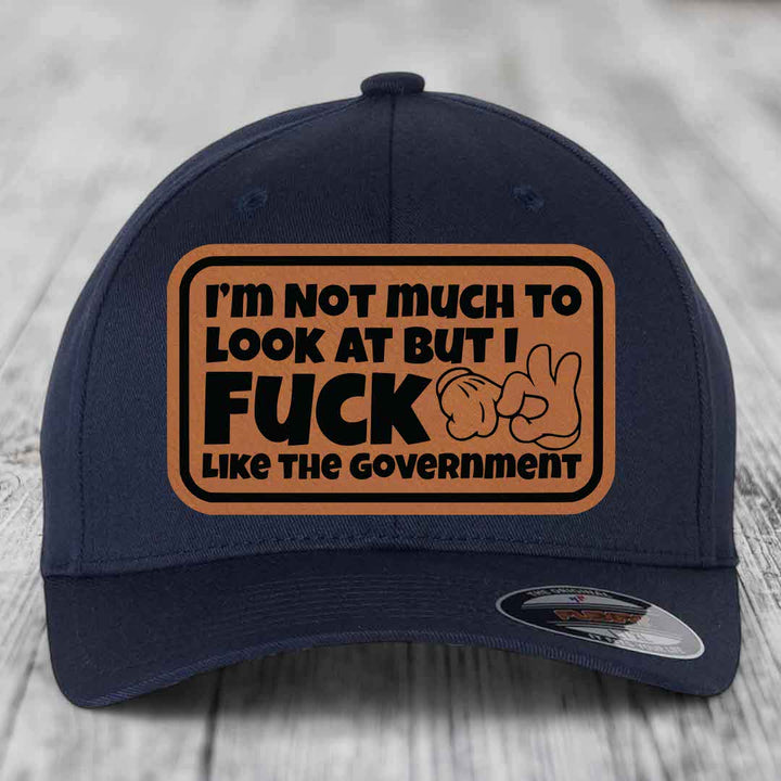 Im Not Much To Look At, But I F*ck Like The Government - Leather Patch Hat - Rawhide to Black Patch - Flexfit 6277 Fitted Hat