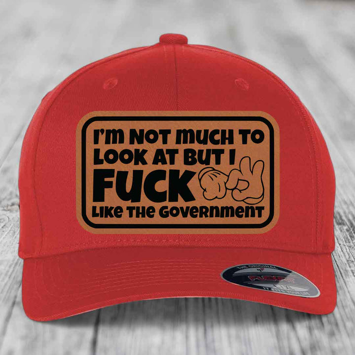 Im Not Much To Look At, But I F*ck Like The Government - Leather Patch Hat - Rawhide to Black Patch - Flexfit 6277 Fitted Hat