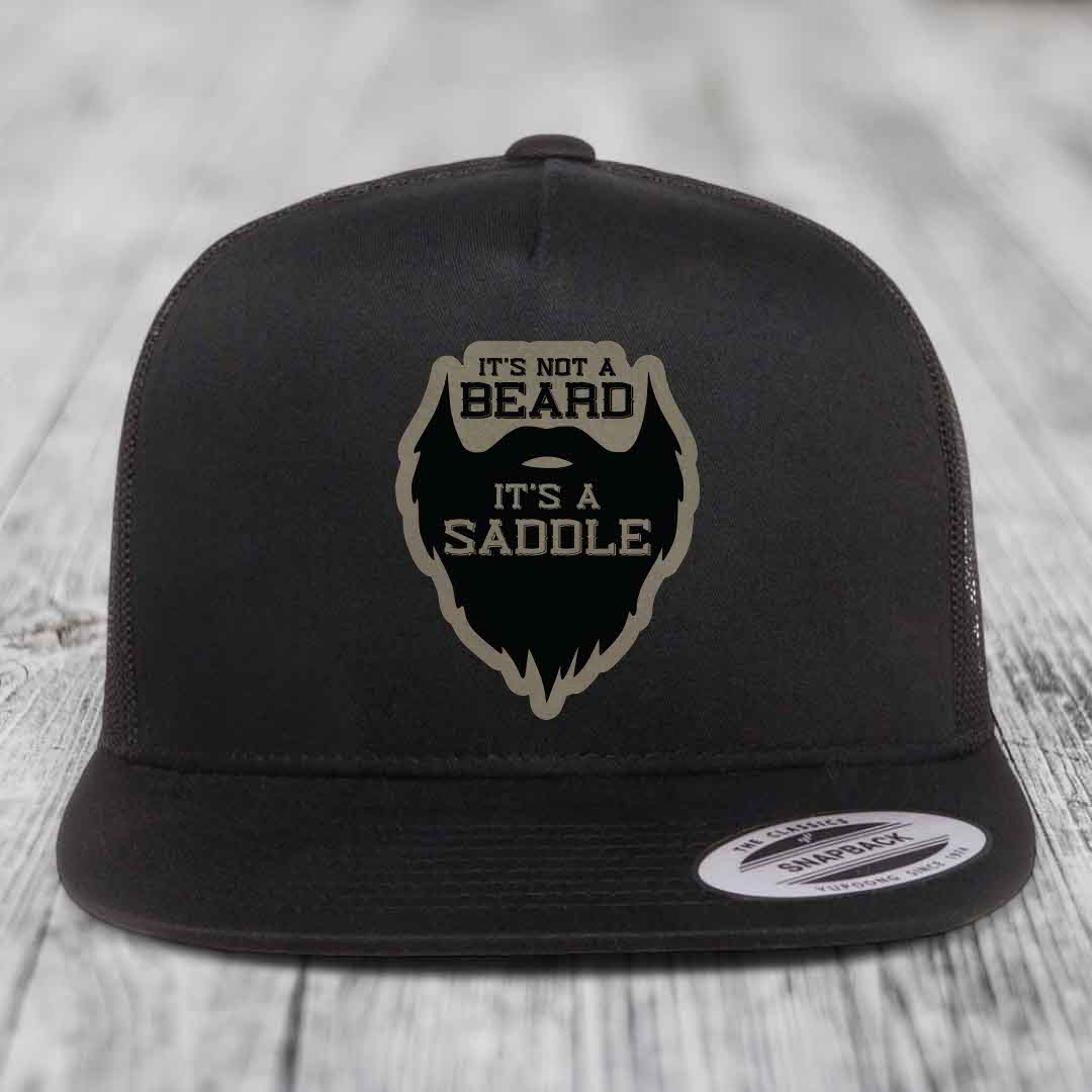 Black snapback hat with a beige and black patch that reads &